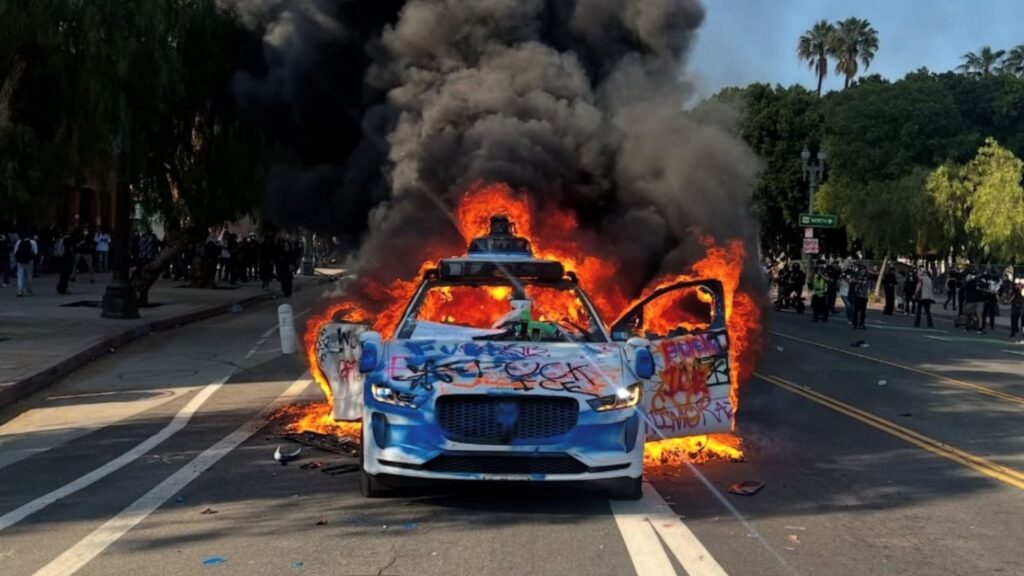 A Waymo robotaxi on set on fire by anti-ICE rioters in LA.