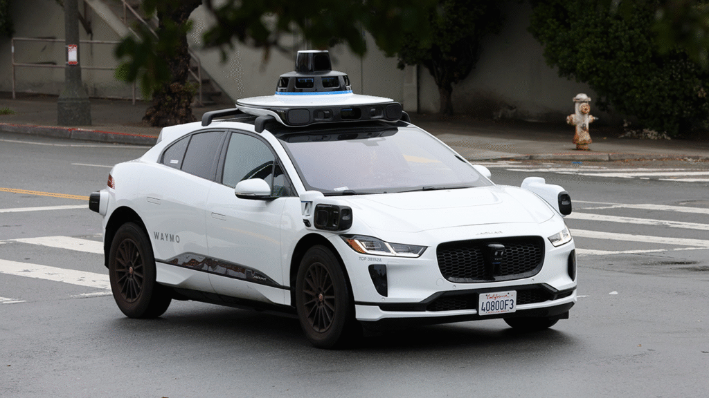 A Waymo robotaxi driving by a Zebra crossing in San Francisco.