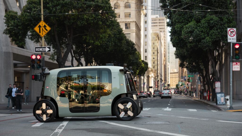 A zoox robotaxi racing down the road