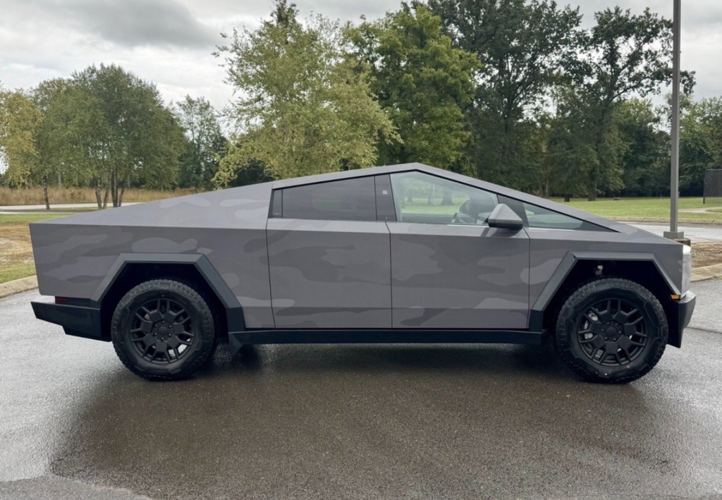 A sharp grey Tesla Cyberbeast parked along the road.