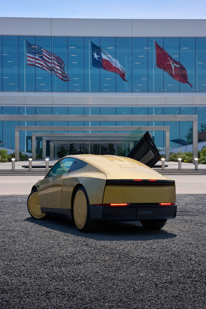 A Tesla cybercab parked outside Tesla's gigafactory.